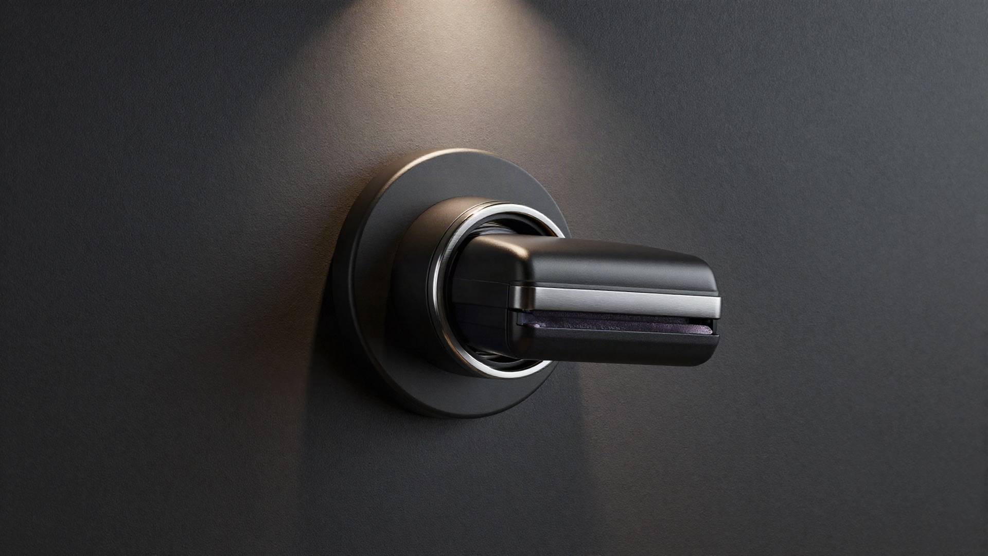 Matte black central vacuum wall inlet on a charcoal wall